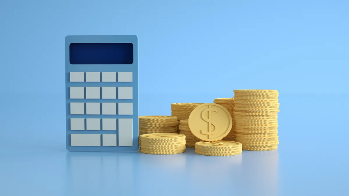 Calculator beside stacks of coins