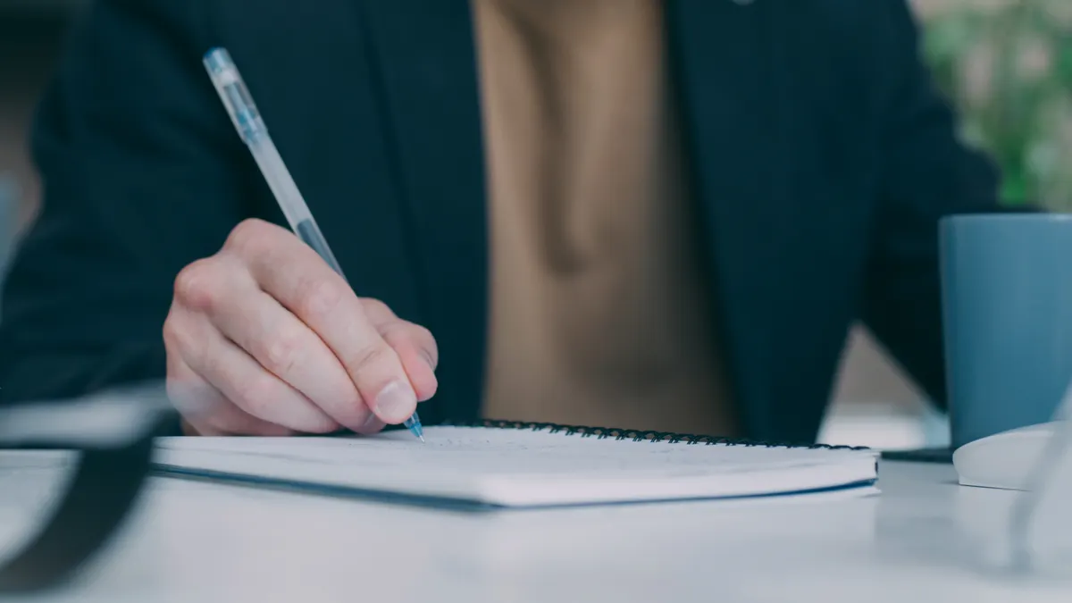 Managed AI writing services vs DIY tools: when to hire a vendor Managed AI writing services vs DIY tools: when to hire a vendor — Close-up of Person Writing in Notebook